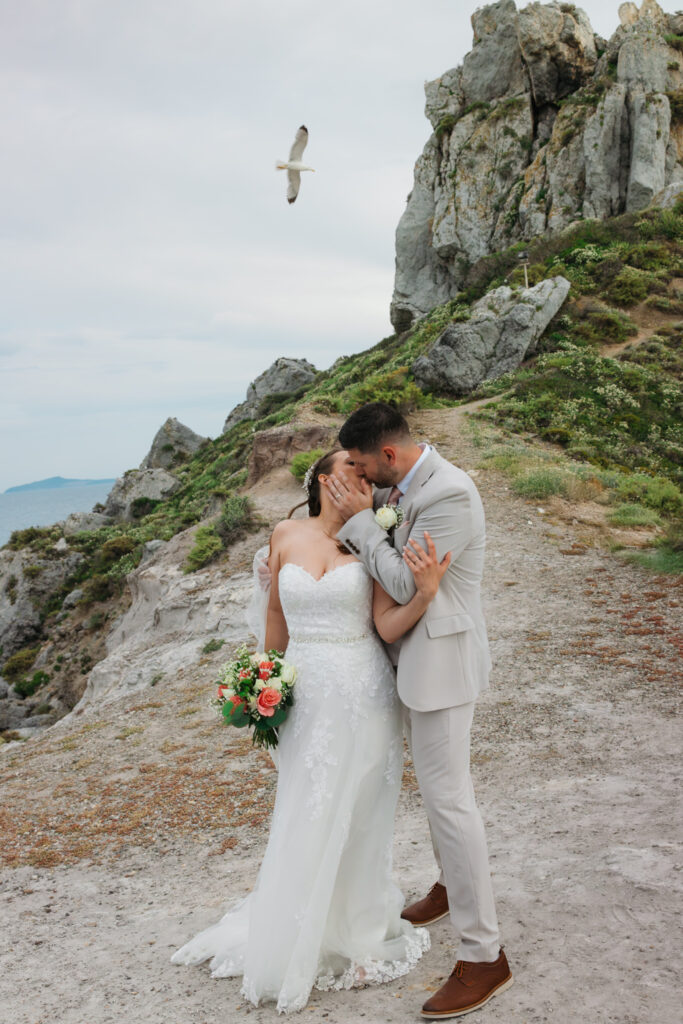 Outdoors island wedding ceremony, editorial photography, destination wedding at Agios Stephanos, Kastri island in KOS, Greece. Couple portraits at the island hills, with some green and ocean views.