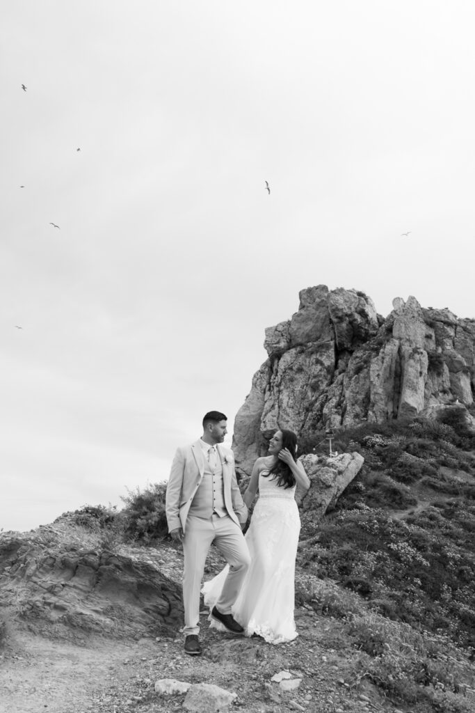 Outdoors island wedding ceremony, editorial photography, destination wedding at Agios Stephanos, Kastri island in KOS, Greece. Couple portraits at the island hills, with some green and ocean views.