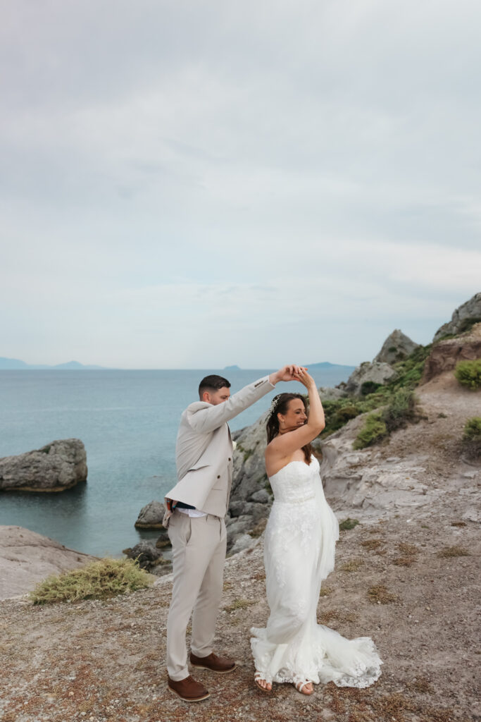 Outdoors island wedding ceremony, editorial photography, destination wedding at Agios Stephanos, Kastri island in KOS, Greece. Couple portraits at the island hills, with some green and ocean views.