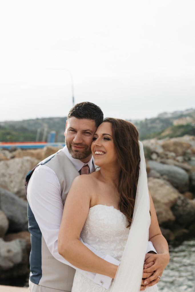 Outdoors island wedding ceremony, editorial photography, destination wedding at Agios Stephanos, Kastri island in KOS, Greece. Bride and groom couple photos by the pier.