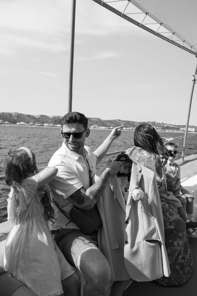 Wedding guests arriving by boat for outdoors island wedding ceremony, editorial photography, destination wedding at Agios Stephanos, Kastri island in KOS, Greece.