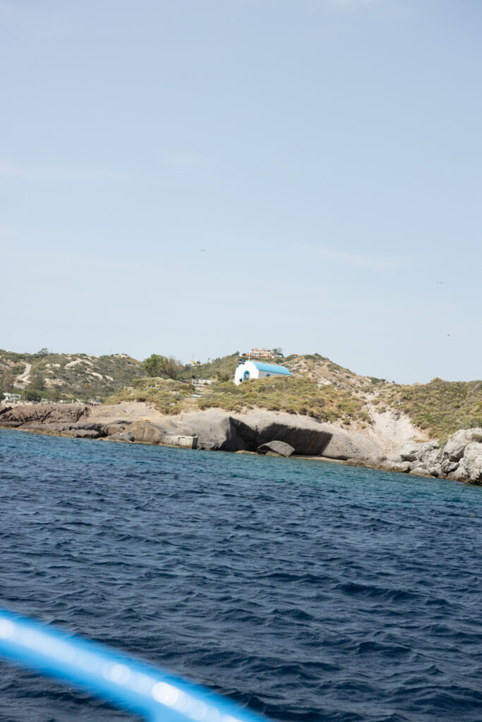 Outdoors island wedding ceremony, editorial photography, destination wedding at Agios Stephanos, Kastri island in KOS, Greece. Ocean view from the island.
