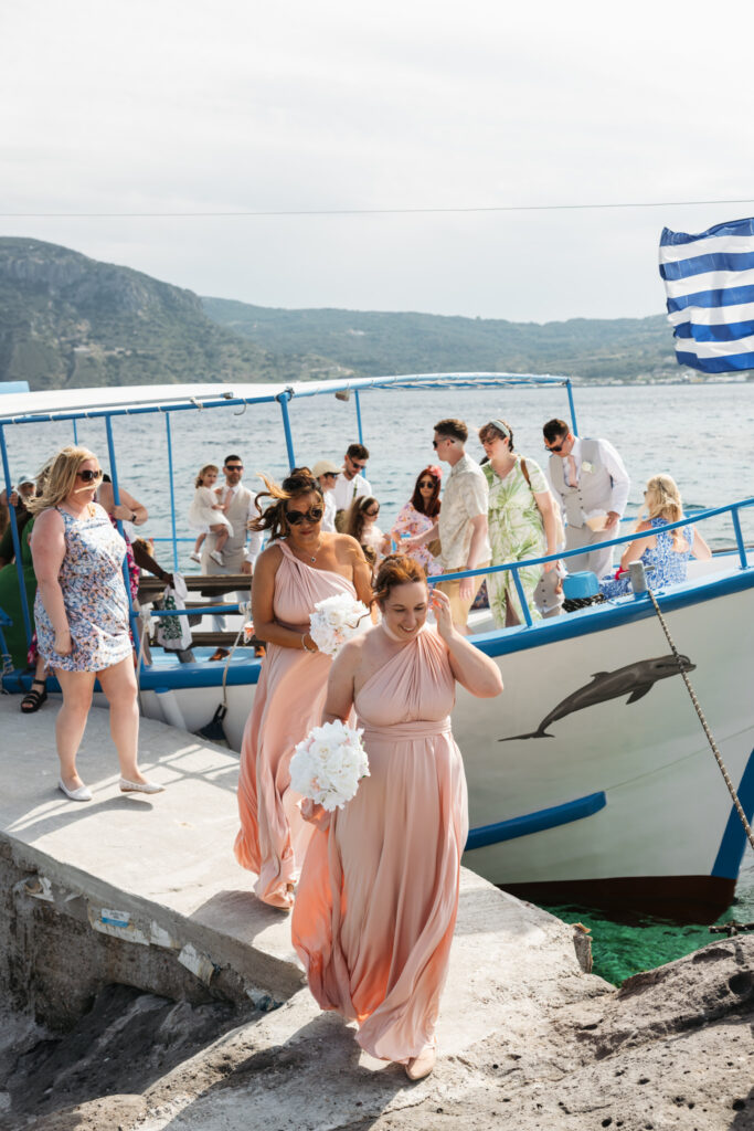 Wedding guests arriving by boat for outdoors island wedding ceremony, editorial photography, destination wedding at Agios Stephanos, Kastri island in KOS, Greece.