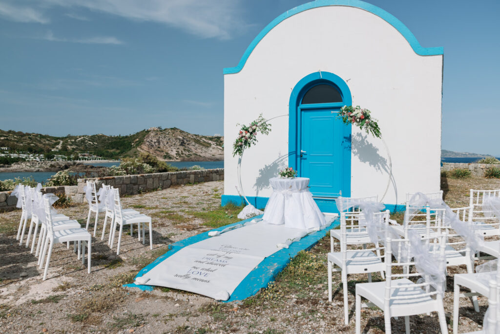 Outdoors island wedding ceremony, editorial photography, destination wedding at Agios Stephanos, Kastri island in KOS, Greece. Greek chapel.