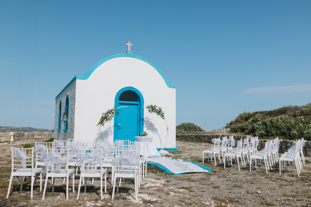 Outdoors island wedding ceremony, editorial photography, destination wedding at Agios Stephanos, Kastri island in KOS, Greece. Greek chapel.