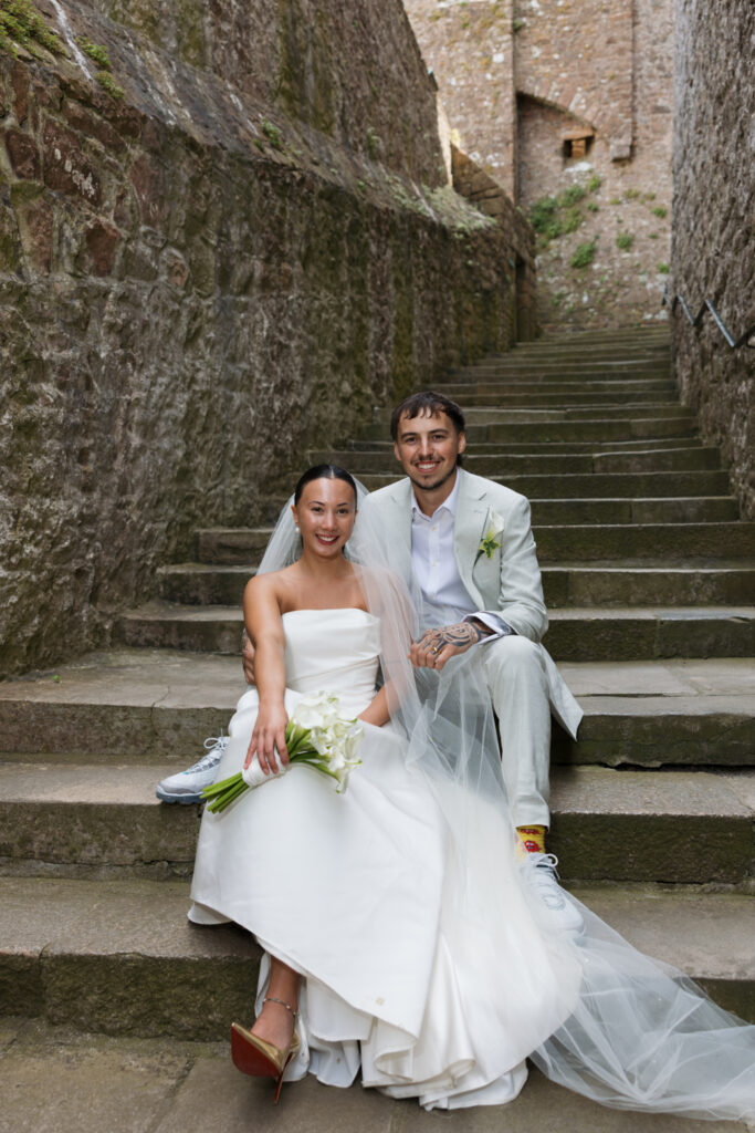 editorial wedding photographer at Gorey castle month Orgueil castle jersey Channel Islands, editorial couple portraits, asian bride from Hong Kong, British groom