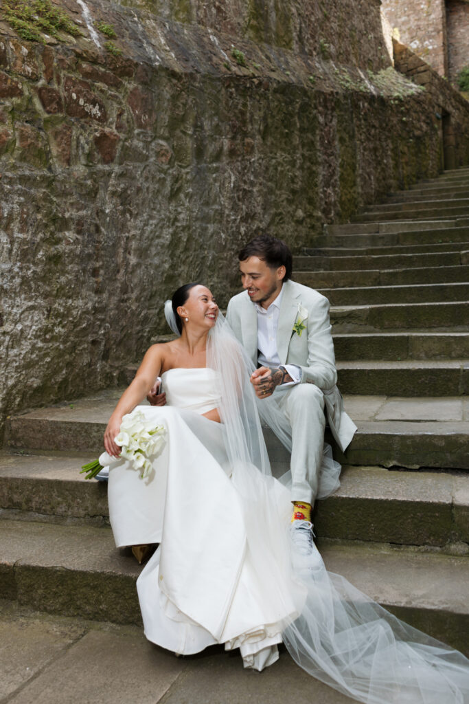editorial wedding photographer at Gorey castle month Orgueil castle jersey Channel Islands, editorial couple portraits, asian bride from Hong Kong, British groom
