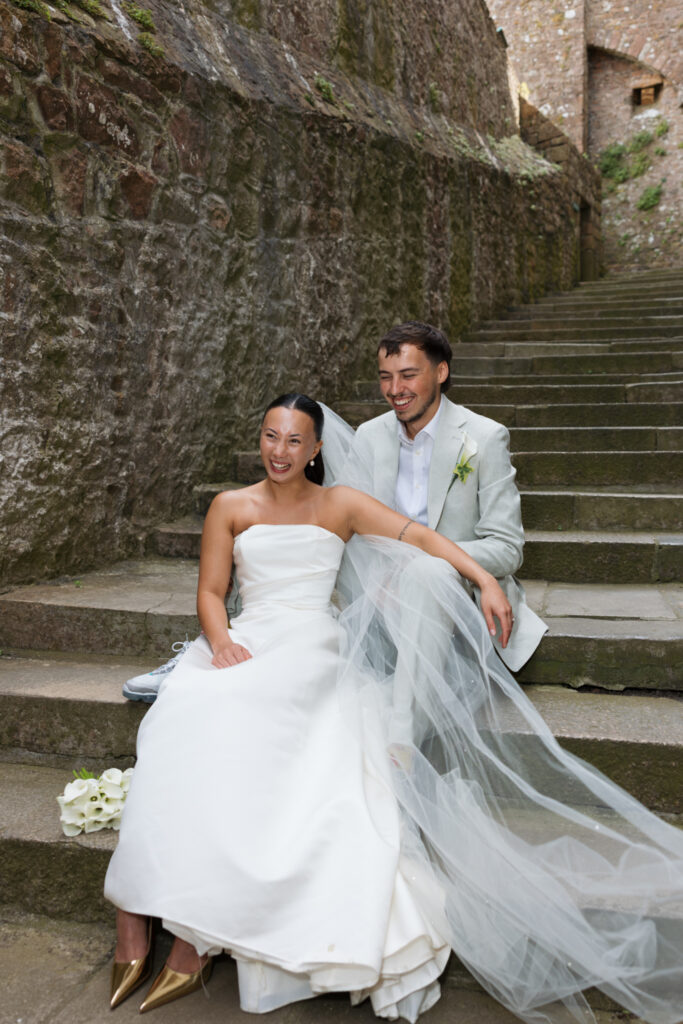 editorial wedding photographer at Gorey castle month Orgueil castle jersey Channel Islands, editorial couple portraits, asian bride from Hong Kong, British groom