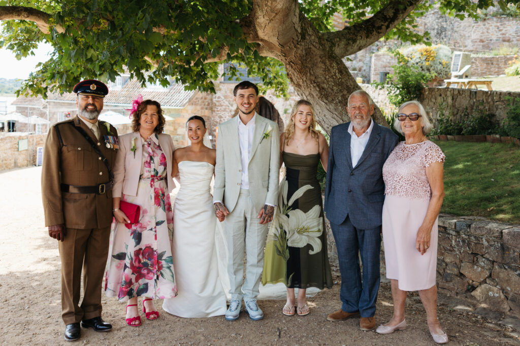 editorial wedding photographer at Gorey castle month Orgueil castle jersey Channel Islands, formal family photos, asian bride, military father of the groom