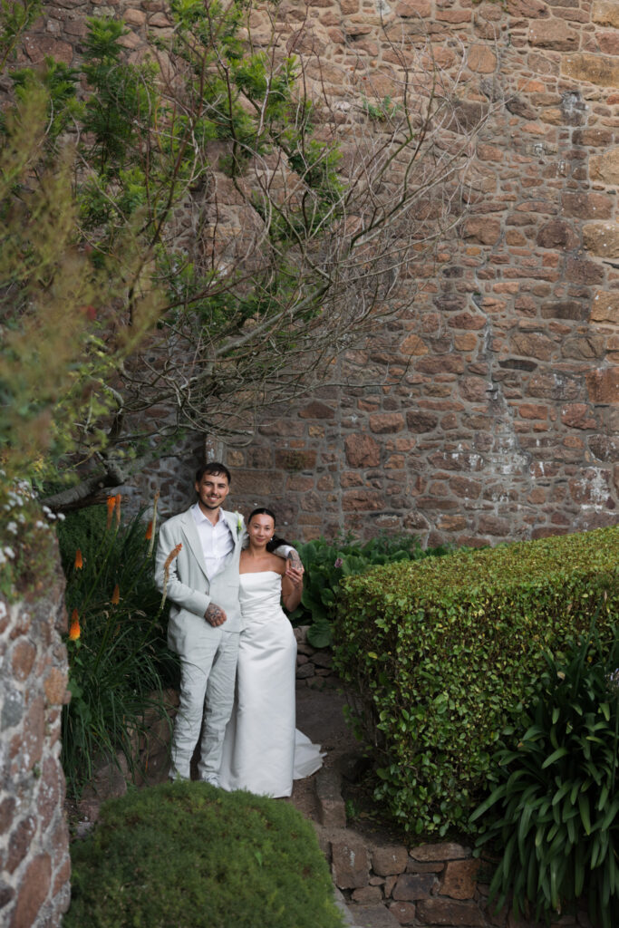 editorial wedding photographer at Gorey castle month Orgueil castle jersey Channel Islands, editorial couple portraits, asian bride from Hong Kong, British groom