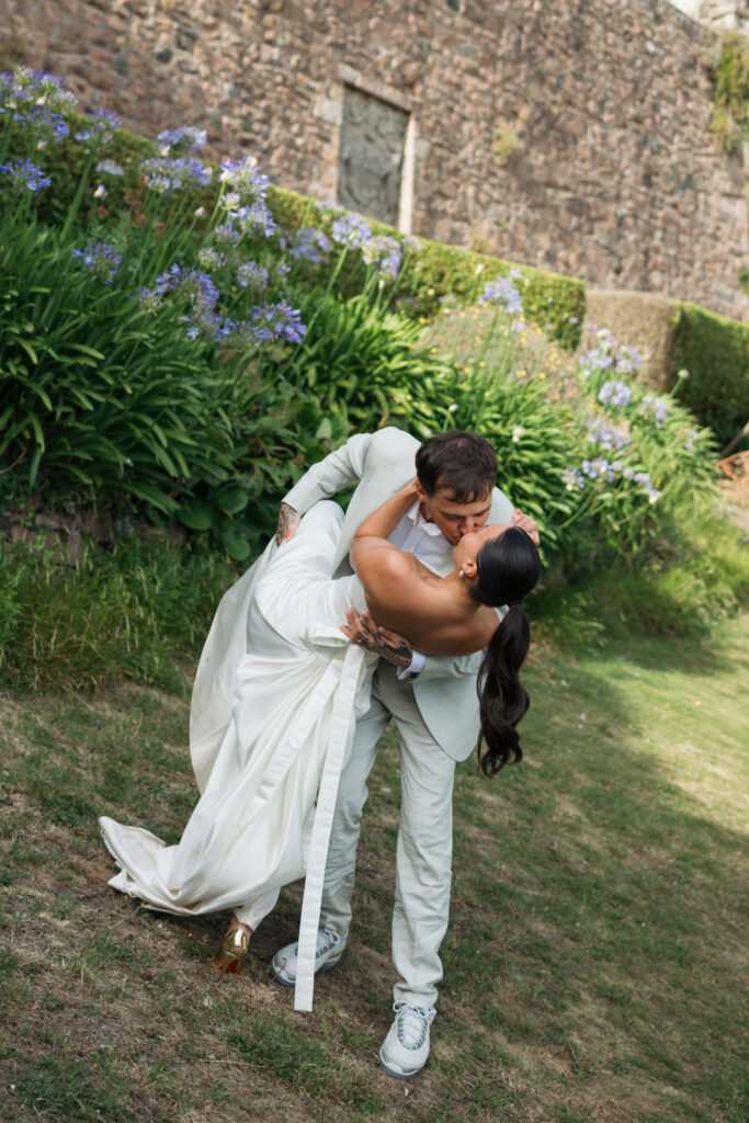 editorial wedding photographer at Gorey castle month Orgueil castle jersey Channel Islands, editorial couple portraits, asian bride from Hong Kong, British groom, kiss dip