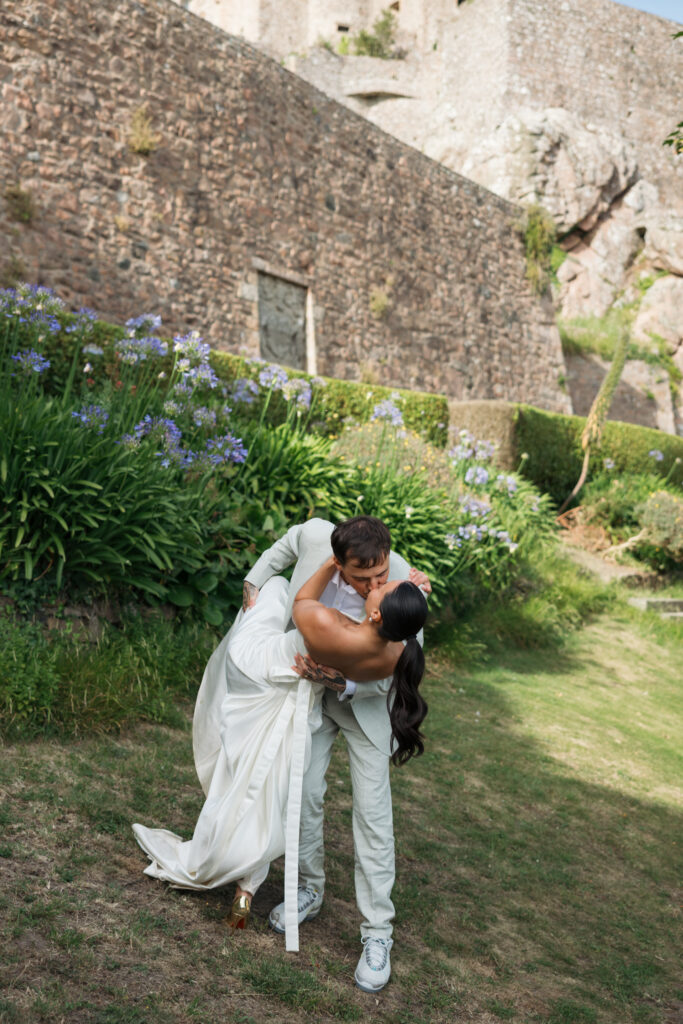 editorial wedding photographer at Gorey castle month Orgueil castle jersey Channel Islands, editorial couple portraits, asian bride from Hong Kong, British groom, kiss dip