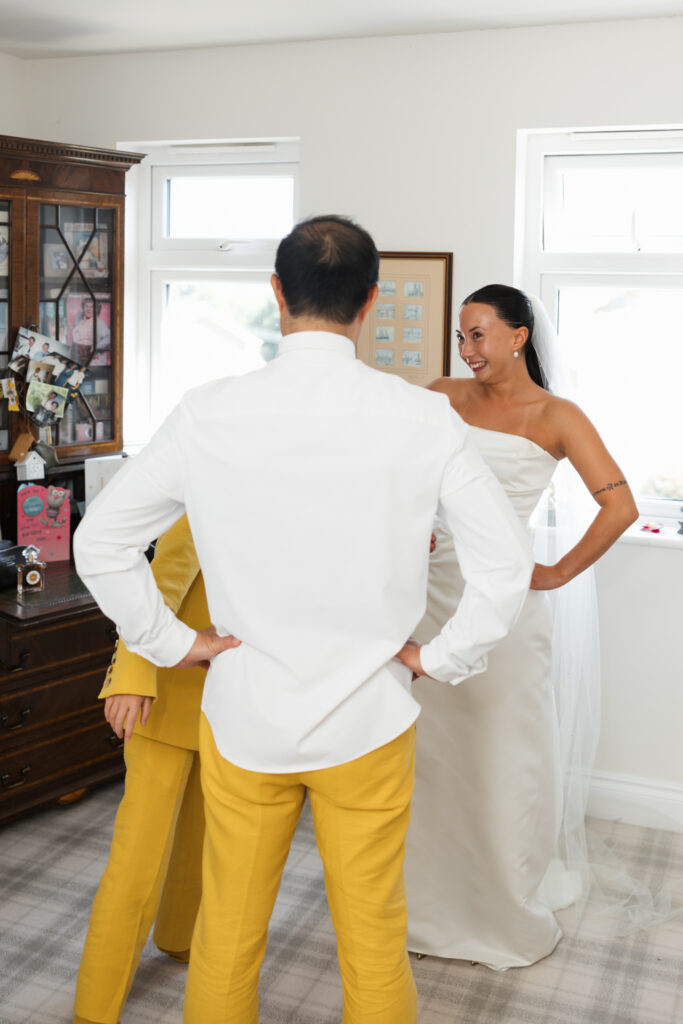 editorial flash bridal prep, asian bride dark hair, editorial wedding photos at Gorey castle month Orgueil castle jersey Channel Islands First look with dad
