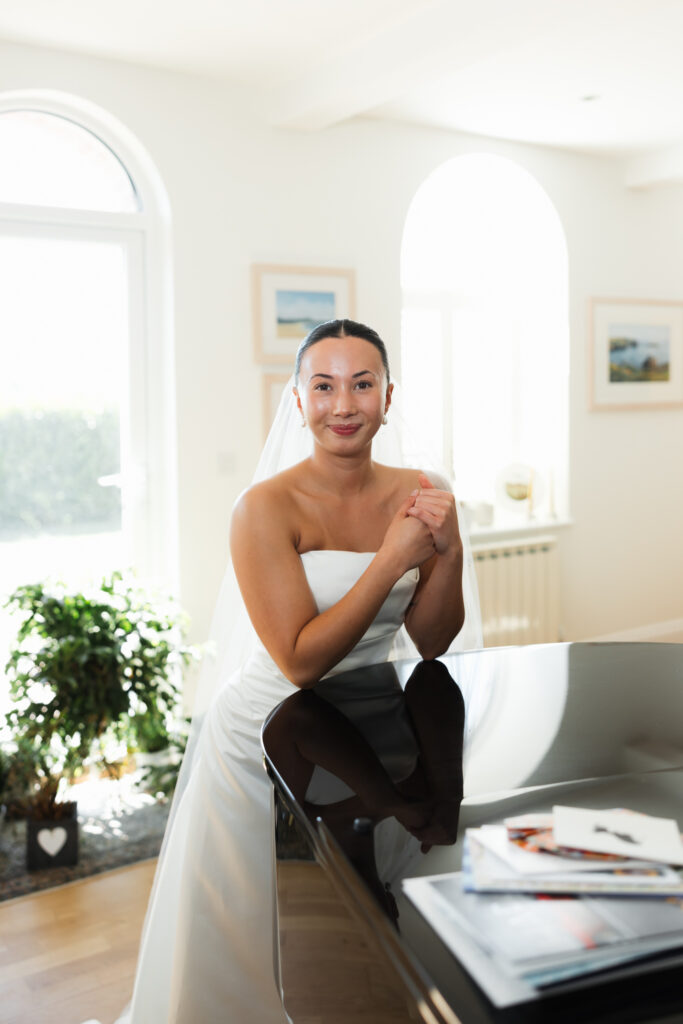 editorial flash bridal prep, asian bride dark hair, editorial wedding photos at Gorey castle month Orgueil castle jersey Channel Islands, bridal portraits by the piano