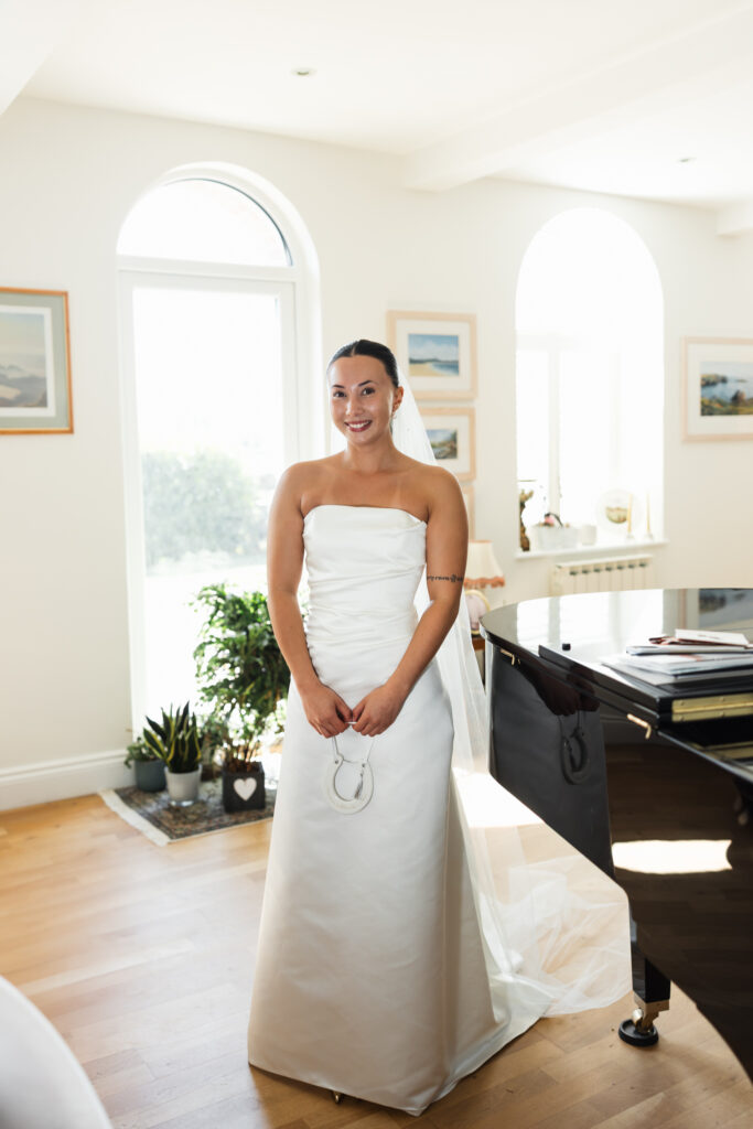 editorial flash bridal prep, asian bride dark hair, editorial wedding photos at Gorey castle month Orgueil castle jersey Channel Islands, bridal portraits by the piano