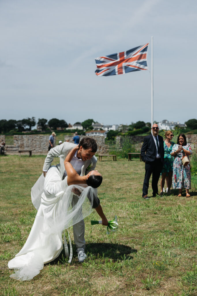 editorial wedding photographer at Gorey castle month Orgueil castle jersey Channel Islands, welcome drinks and cocktail hour, kiss dip